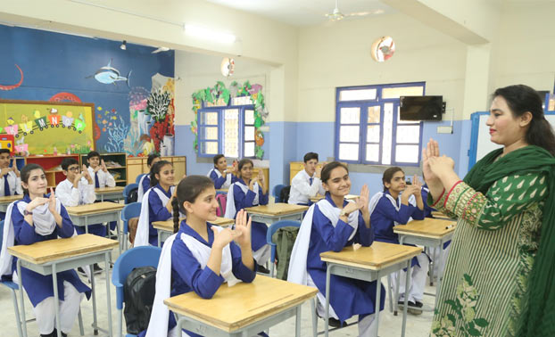 Teacher teaching a classroom of Deaf students through sign language